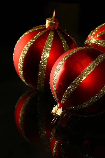 Red glass ornament on black — Stock Photo, Image