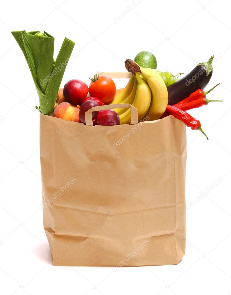 A grocery bag full of healthy fruits and vegetab