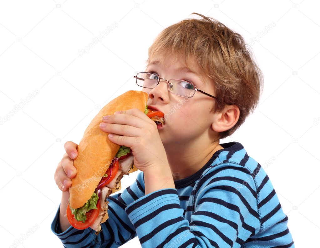 Boy eating large sandwich