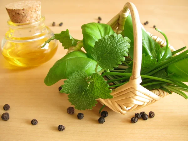 Little basket with herbs and olive oil — Stock Photo, Image
