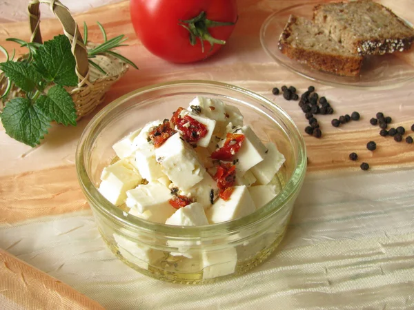 Cheese in herbs oil — Stock Photo, Image