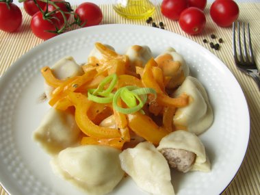 Pelmeni filled with minced meat and yellow paprika vegetables clipart