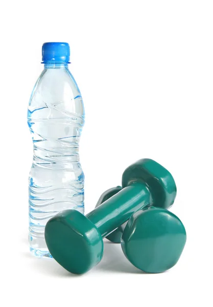 Green dumbbells and a bottle of water — Stock Photo, Image
