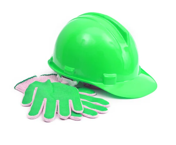 Groene veiligheidshelm en handschoenen Stockfoto