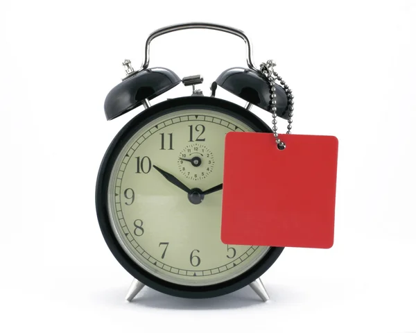 Alarm clock with a tag — Stock Photo, Image