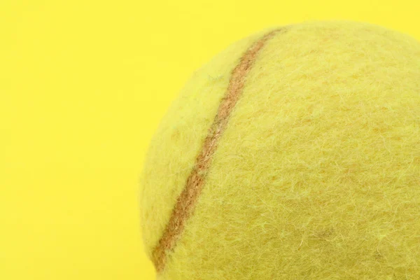 Профіль тенісного м'яча на жовтому — стокове фото