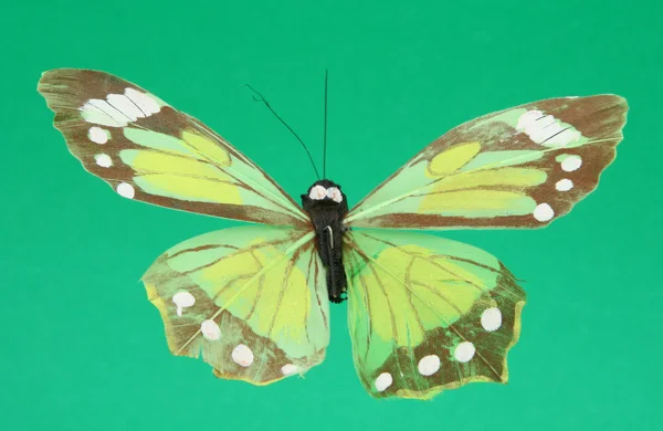 Yeşil zemin üzerine yapay kelebek — Stok fotoğraf