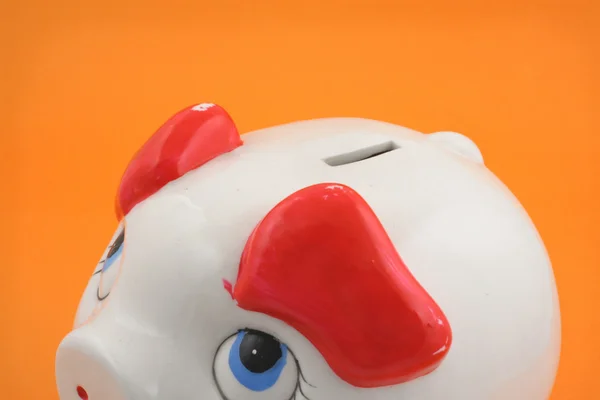 Piggy bank on orange — Stock Photo, Image