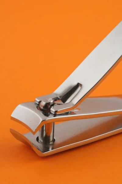 Nail clippers on orange — Stock Photo, Image