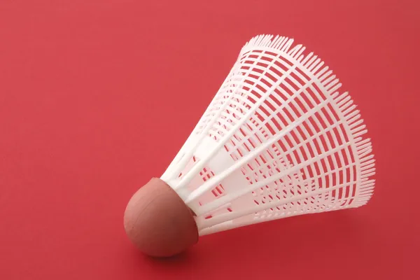 Shuttlecock on red — Stock Photo, Image