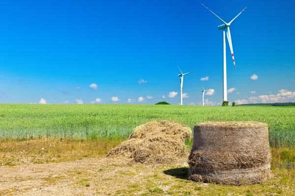 Hay bale with wind turbines — Stock Photo, Image