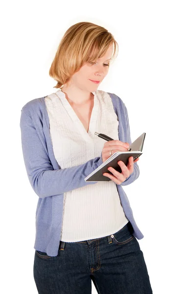Young woman writes in a notebook — Stock Photo, Image