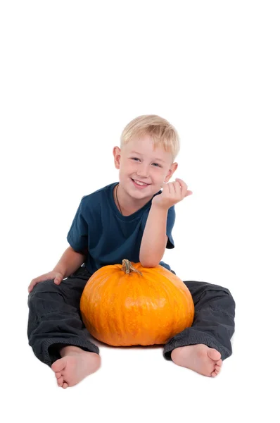 stock image Sitting boy with pumpkin