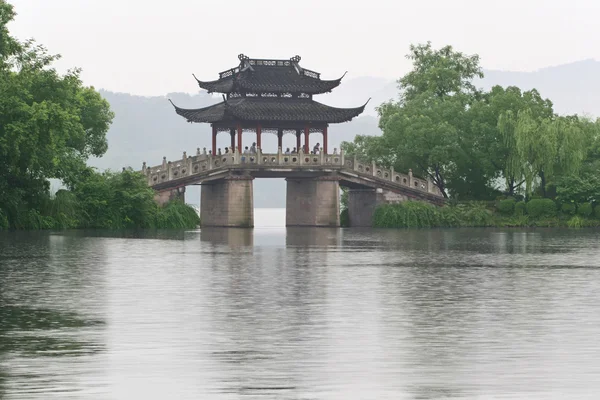 stock image Old bridge and rain of chinese west lake