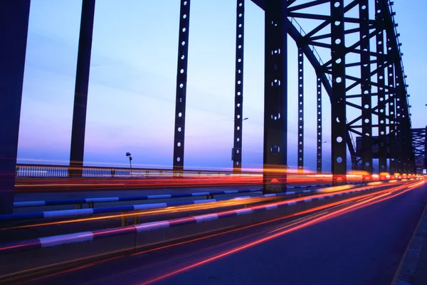 stock image Light trails on the bridge at dusk