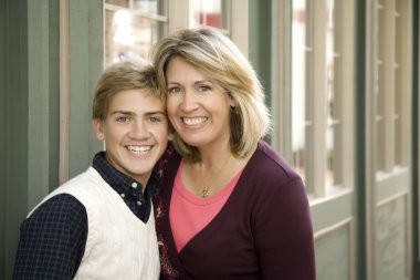 Mom and Son in Front of Store clipart