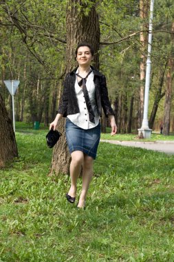 Girl walking in park clipart