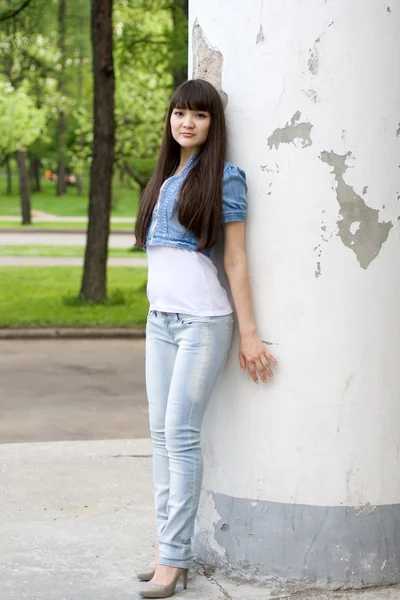 Dziewczyna stoi w pobliżu kolumna — Zdjęcie stockowe