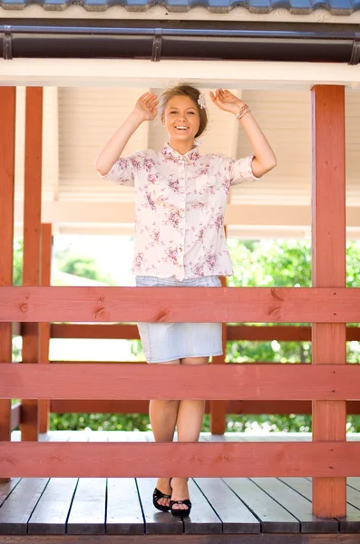 Girl standing on a veranda — Stock Photo, Image
