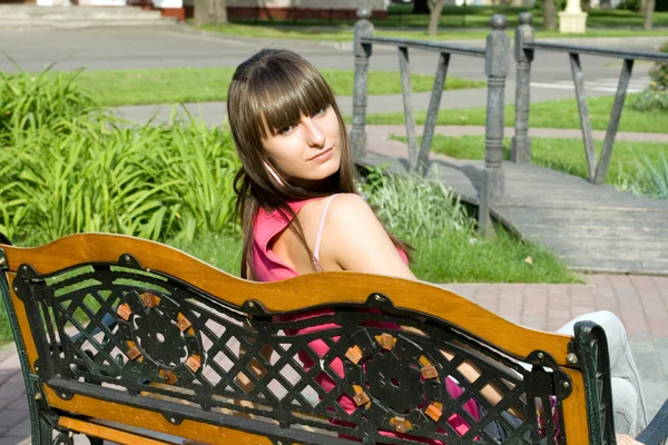 Girl sitting on bench Stock Image
