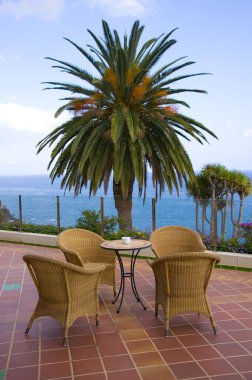 Coffee table with four rattan chairs and clipart