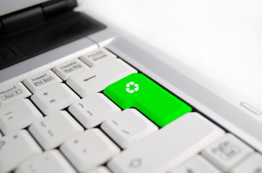 Computer keyboard with green Enter key with recycling symbol, business conc clipart