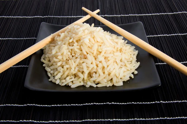 Plate rice with chopsticks — Stock Photo, Image
