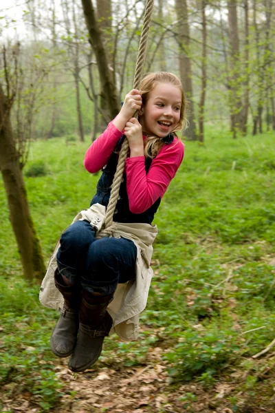 Girl swings on rope — Stock Photo, Image