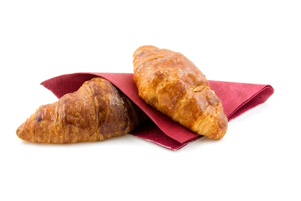 Två croissanter på röd servett — Stockfoto