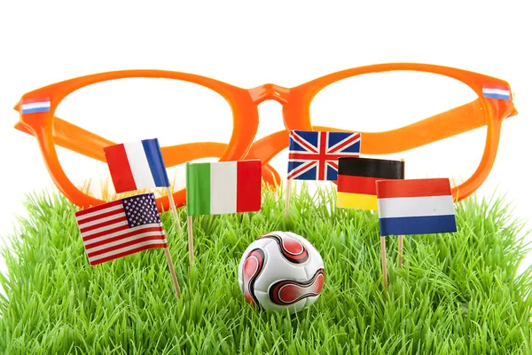 Flags and ball on soccer field — Stock Photo, Image