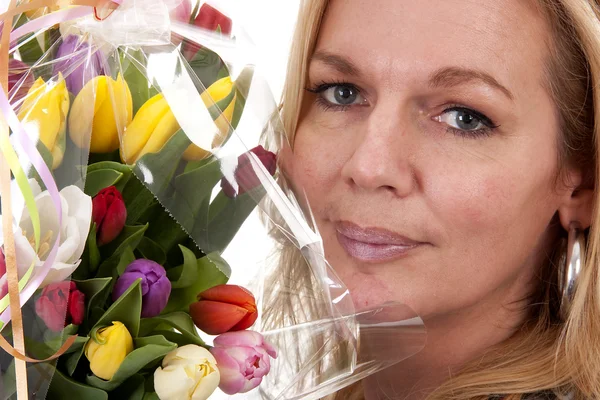 stock image Woman with Dutch tulip flowers