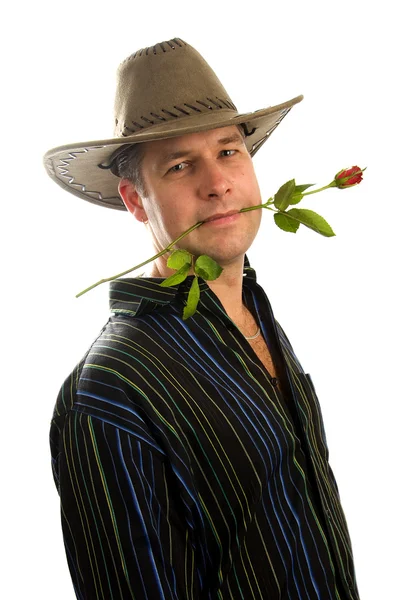 Cowboy in love with rose in mouth — Stock Photo, Image