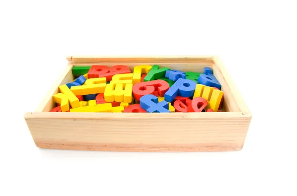 Caixa de madeira com letras coloridas — Fotografia de Stock