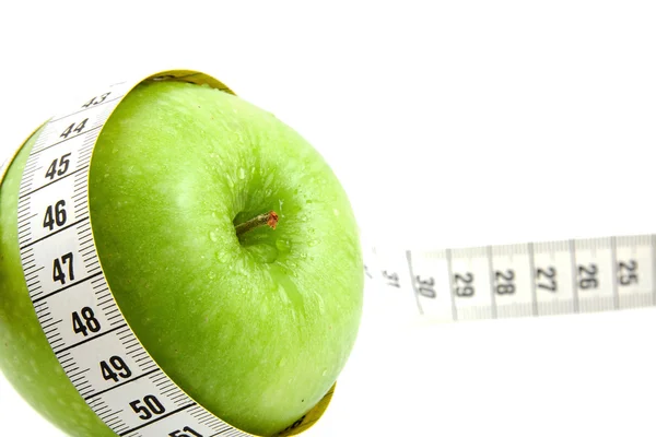 Fresh green apple with measure tape — Stock Photo, Image