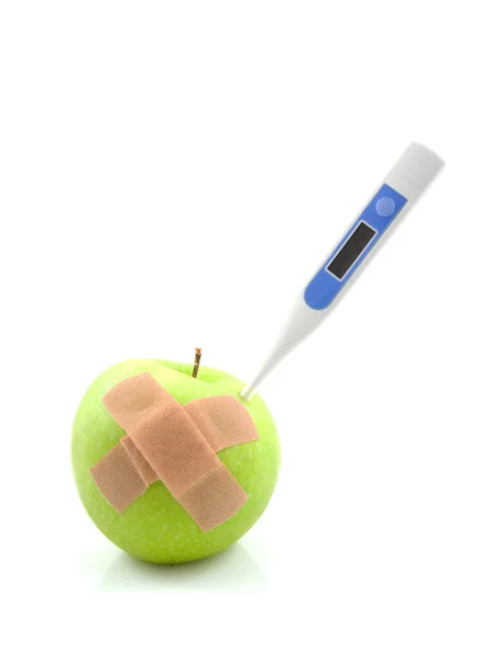 Sick apple with thermometer and patches — Stock Photo, Image