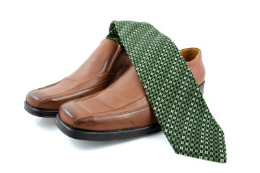 Pair of brown male business shoes and green tie clipart