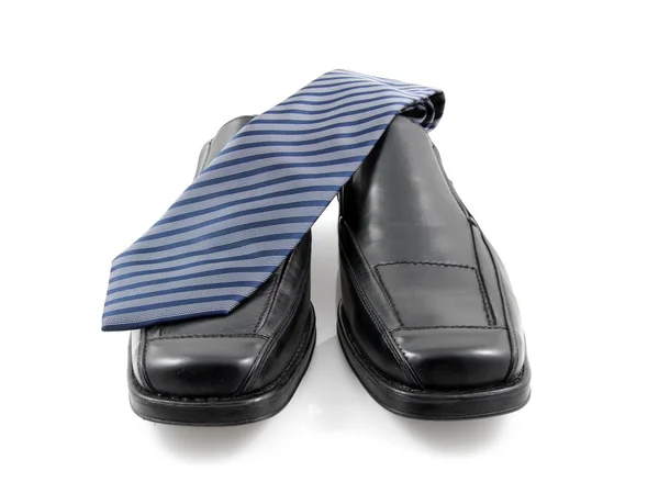 Pair of black male business shoes and blue tie — Stock Photo, Image