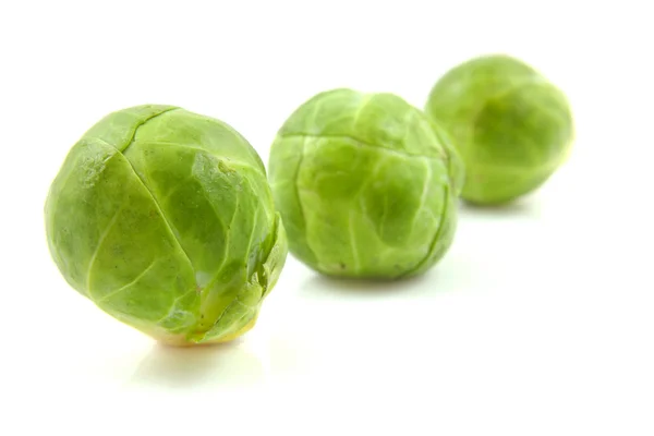 Three Brussels sprouts in a row — Stock Photo, Image