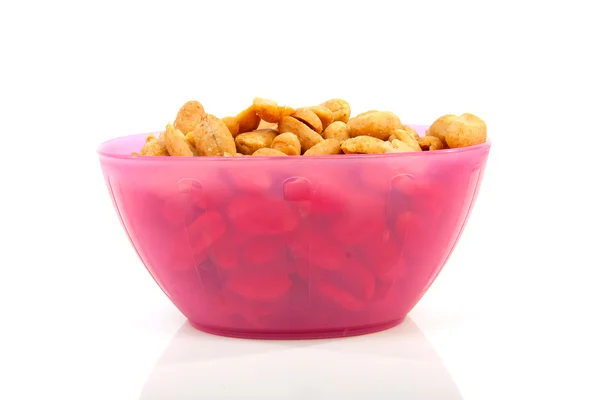 Pink bowl with salted peanuts — Stock Photo, Image