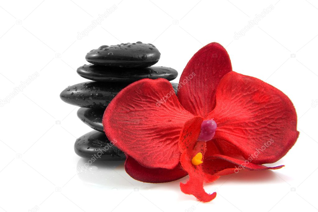 Stacked black spa stones with silk orchid