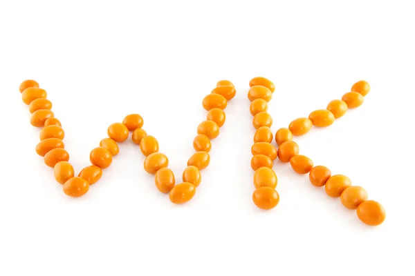 Word WK in orange peanuts — Stock Photo, Image