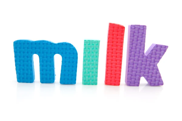 Palabra leche en letras de espuma — Foto de Stock