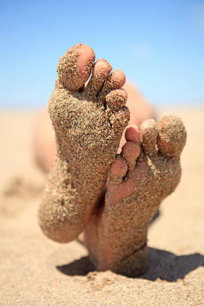 Bottom of feet covered with sand — Stok fotoğraf