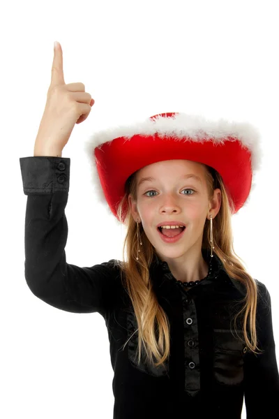 Flicka med jul hatt pekar — Stockfoto