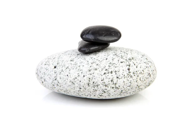 Grande roccia grigia con piccoli neri — Foto Stock