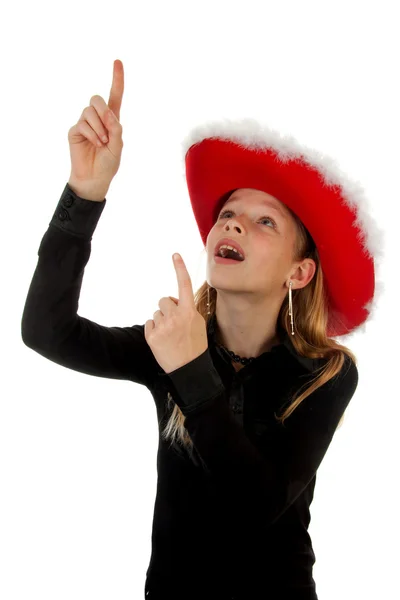 Girl with christmas hat is pointing — Stock Photo, Image