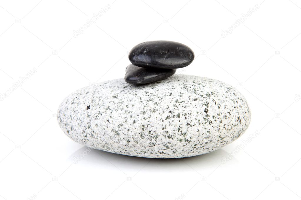Big grey rock with little black ones