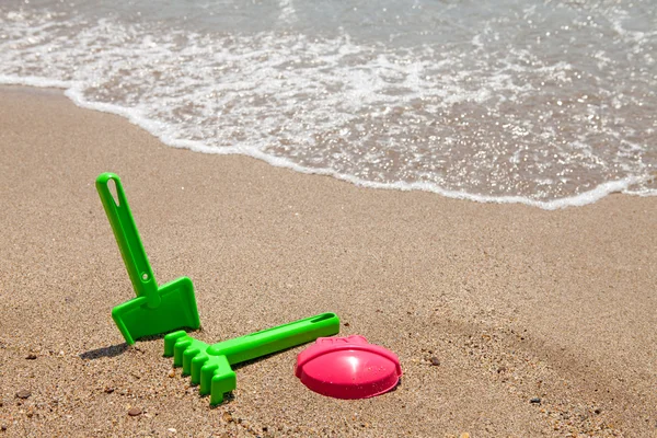 Plastové barevné hračky na pláži — Stock fotografie
