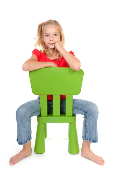 Blonde girl on green chair — Stock Photo, Image