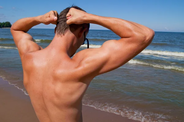 stock image The sports young man in the sea